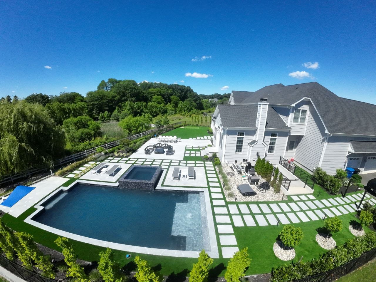 Resort-style pool surround with artificial turf and pavers