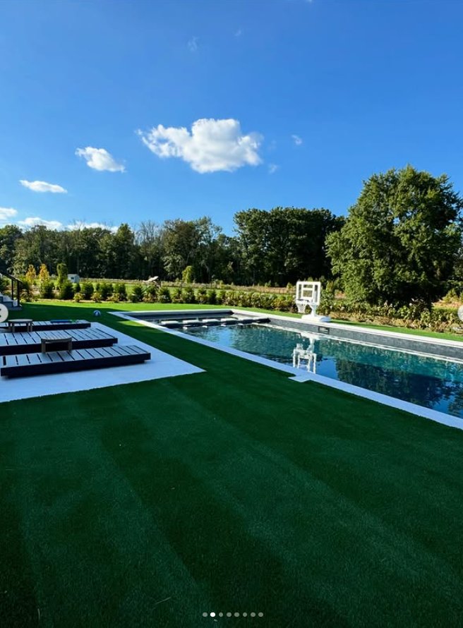 Poolside turf with wooden lounge chairs