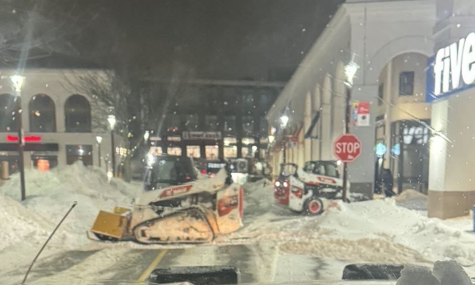 Turf Boss Bobcat skid steers clearing a town center